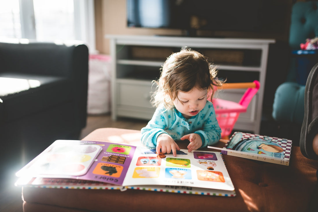 baby reading picture book