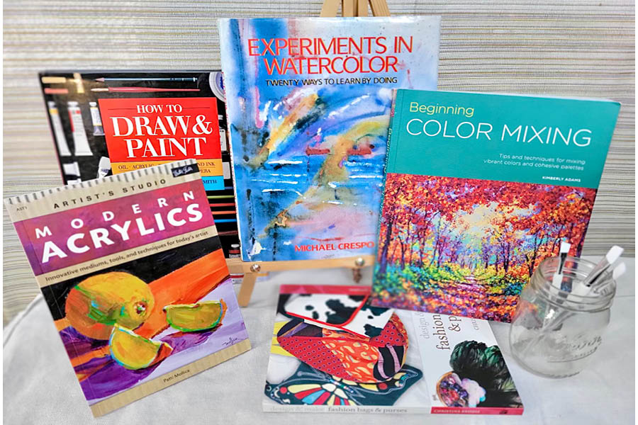 Various art books involving paint, acrylics, and water color